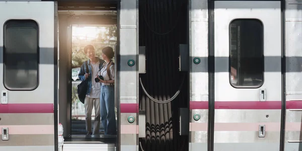 stock image Asian couple on a train have happy moment. Tourism and travel in the summer.