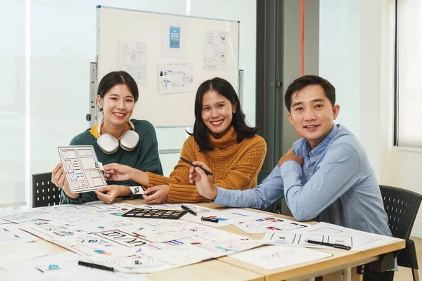 Stock image Team of ux developer and ui designer brainstorming interface wireframe design.Creative digital development agency.