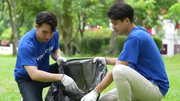 Jóvenes Voluntarios Asiáticos Con Bolsas Basura Limpiando Área Del Parque — Vídeo de stock