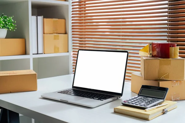 Small Business delivery modern room with laptop white screen at home office.