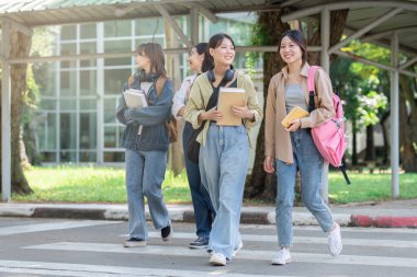 Group of Young Asian student walking and talking at university before class room. education, back to school concept.