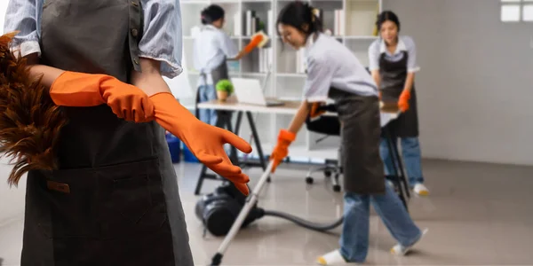 Team of maid housekeeping service cleaning wearing uniform cleaning at office.