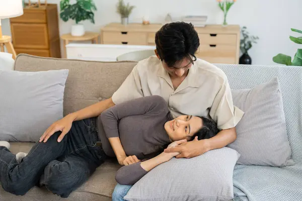 Happy young couple relax on sofa in living room together.Romantic day together. Valentines Day concept.