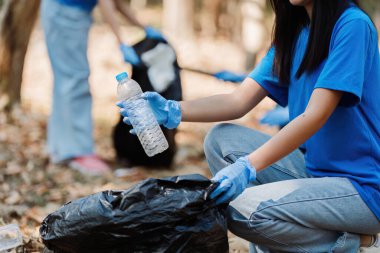 Geri dönüşüm için doğayı çöplerden ve plastik atıklardan temizleyen gönüllüler ve topluluk üyeleri..