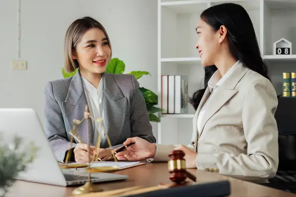 stock image Lawyer working with client discussing contract document in office, consulting to help customer.