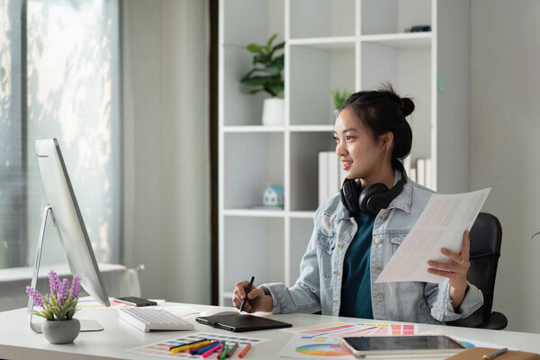 Graphic UI designer work on computer laptop and with graphic drawing pen after brainstorming unique design with professional developer UX team.