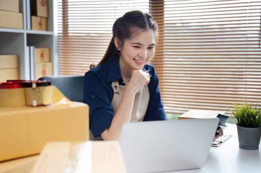 Dizüstü bilgisayar kullanan genç bir girişimci. Nakliyeye, çevrimiçi satışa, e-ticaret konseptine hazırlık.