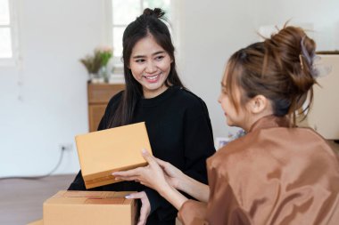 Neşeli bir lezbiyen çift yeni evlerinde kutuları açıyor, birlikte yeni bir sayfa açtıklarında gülümsemelerini ve heyecanlarını paylaşıyorlar..