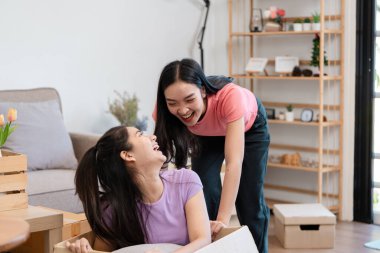 Neşeli, çeşitli bir çift yeni evlerinde kutuları açarken aynı kahkahayı paylaşıyor. Birlikte taşınma sürecinin tadını çıkarıyorlar..