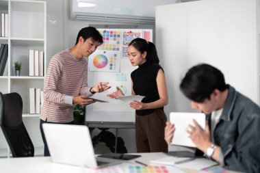 Modern bir stüdyoda, grafik tasarımcıları projelerini etkili bir şekilde rafine etmek için renk örneklerini kullanarak görsel kavramların beyin fırtınası yaparlar..