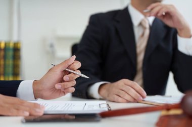 Bir avukatın müvekkiline yasal yükümlülükler ve stratejiler hakkında danışmanlık yaptığı ve iletişimdeki netliği vurguladığı odaklı bir hukuki danışma..