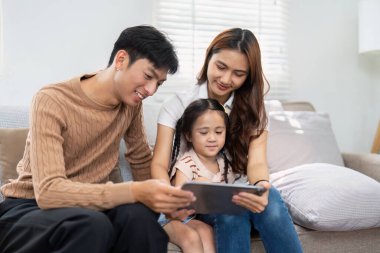 Sevgi dolu bir aile birlikte oturur, eğitici bir videonun keyfini çıkarırlar. Ortak ilgileri, sıcak bir yuva ortamında aile bağlarını öğrenmeyi ve geliştirmeyi teşvik eder..