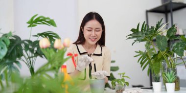 Tutkulu bir bahçıvan çiçeklerini neşeli bir ifadeyle dikkatlice inceler. Kapalı alanda bahçesini yetiştirirken doğaya bağlı hisseder..