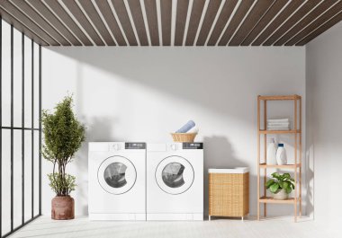 Modern bir ev çamaşırhanesi şık çamaşır makineleri, doğal ışık ve organize depolama çözümleri sergiliyor..