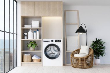 Modern aletleri olan zarif bir çamaşır odası tasarımı ve doğal ışık ve dekorun yarattığı rahat bir ortam..