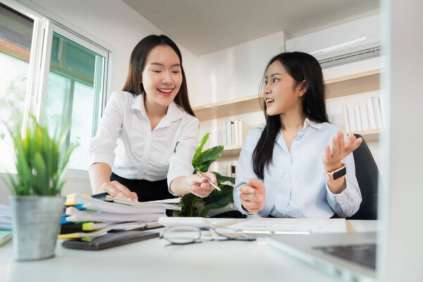 Women share ideas and collaborate on project tasks, emphasizing teamwork and effective communication in a modern workspace.