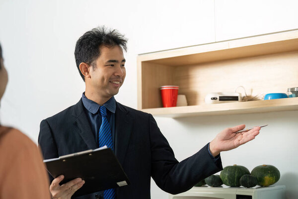 A real estate agent engaging with a client, providing insights and guidance on property options in a friendly atmosphere.