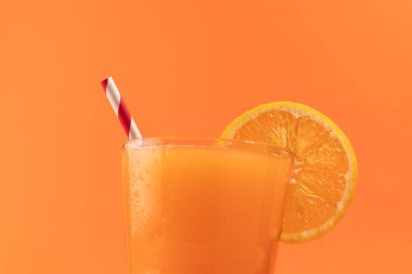 Orange juice isolated on orange background