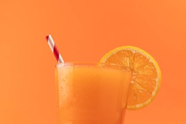 Orange juice isolated on orange background