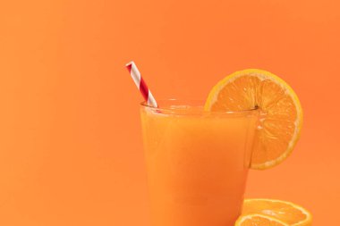Orange juice isolated on orange background