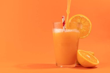Orange juice isolated on orange background