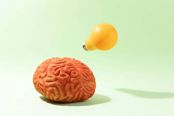 A brain having an idea on red background