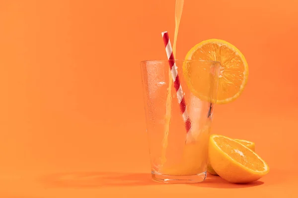 Orange juice isolated on orange background