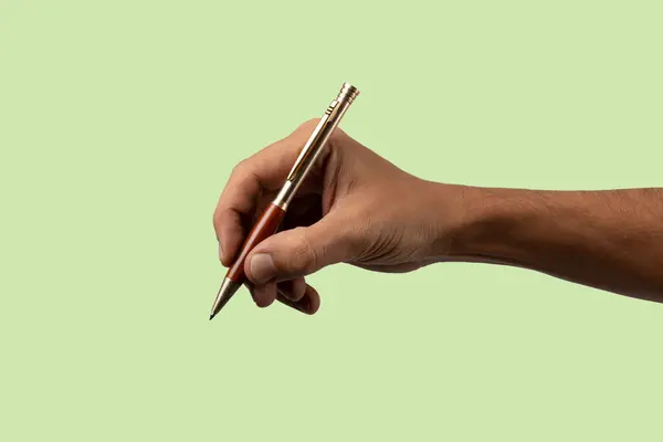 Closeup of male hand holding pen and writing or signing isolated no background