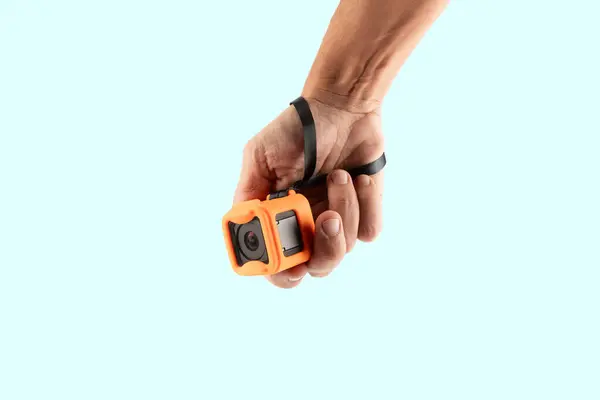 Erkek el, arka planda izole edilmiş bir aksiyon kamerası tutuyor. Yüksek kalite fotoğraf