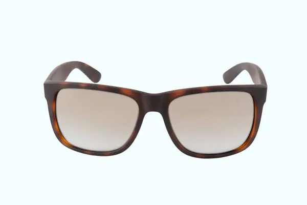 Cyan arka planda izole edilmiş kahverengi güneş gözlükleri. Yüksek kalite fotoğraf