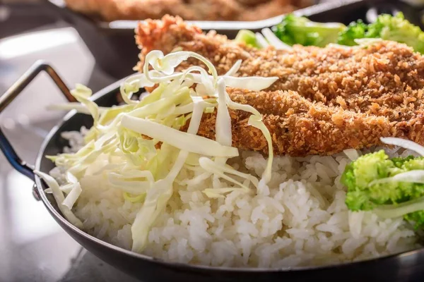 Crispy Pork Cutlet Perfection: Top Close-Up of Deep-Fried Pork Cutlets on Chopped Green Cabbage and Steamed White Rice, Captured in 4K Resolution