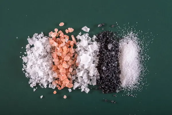 Salt Selection: 4K Ultra HD Image of Variety of Salt on Green Background