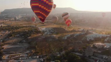 Aerial 4K Video: Sıcak Hava Balonlarının İkonik Çöl Sahnesinde Yükselişinin Görkemli Görüntüsü