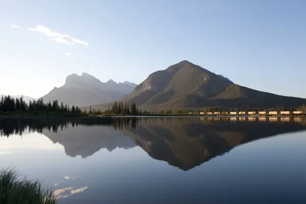 Stock image 4K Ultra HD Image: Freight Train Reflected in Mountain Lake