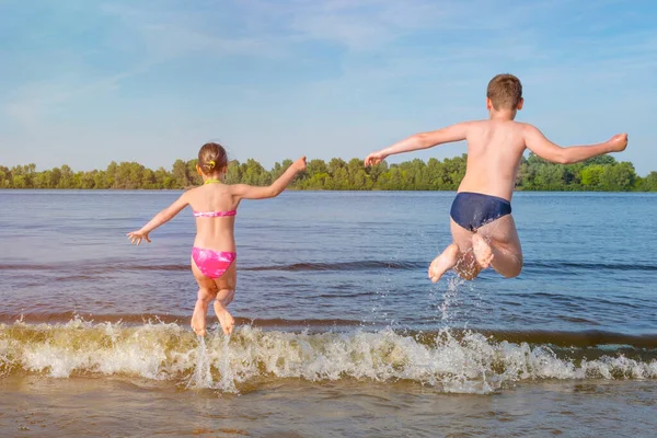 Children Jump River Waves Sunny Day View Back — Stock Photo, Image