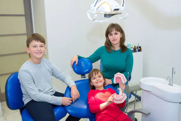 A happy family in a dental office. A family visit to a dentist.