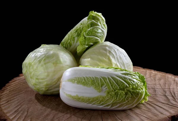 Fresh green garden cabbage on wooden background. Whole fresh green cabbage on wooden background.