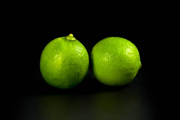 Two Natural Limes Close Black Background Fresh Citrus Fruits — Stock Photo, Image