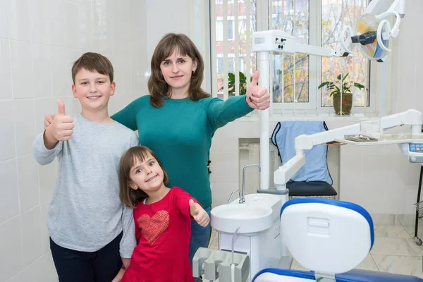 A happy family in a dentists office. Medicine, dentistry and health care.