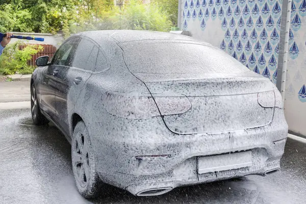 Washing car with soap. Close-up concept. Car in foam.