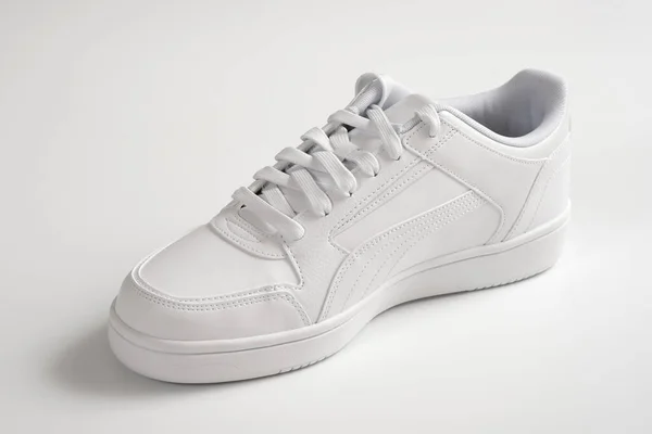 Sports shoes on a white background. White sneaker close up. Sports lifestyle.