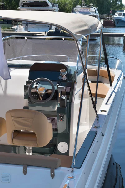 Luxury yacht control wheel and interior of a transport motorboat.