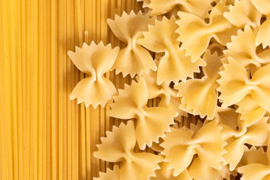 Çiğ makarna farfalle ve spagetti, üst manzara. İtalyan çiğ makarna modeli..