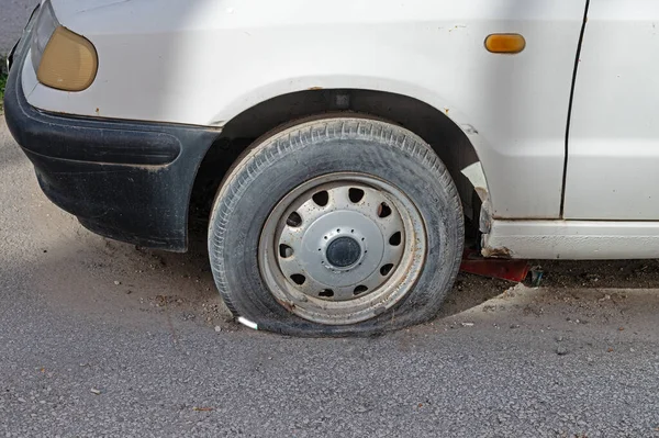 A car with a flat tire.