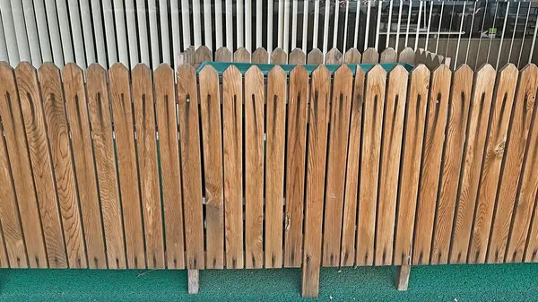 stock image Wooden fence in front of the building.