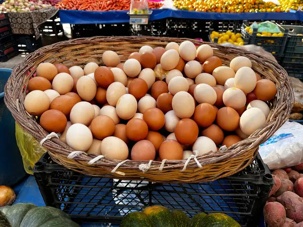 A basket of village eggs on the market stall.