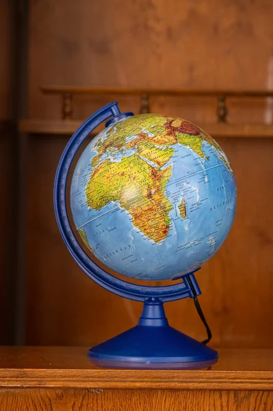 A small school globe on a table.