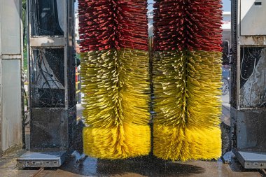 Car washing machine. Auto brush washer clean blue car on automatic carwash station. Automated car washing machine background.