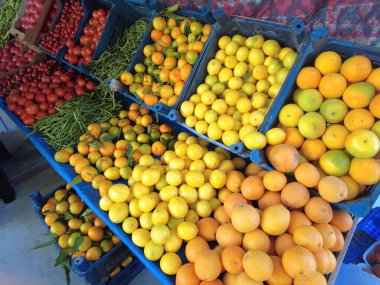 Various vegetables and fruits on display at the grocery stall.