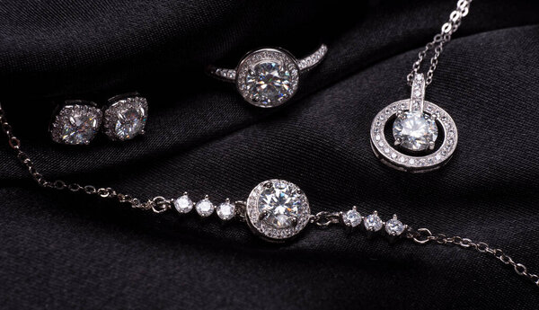 Beautiful silver set with diamonds on a black background